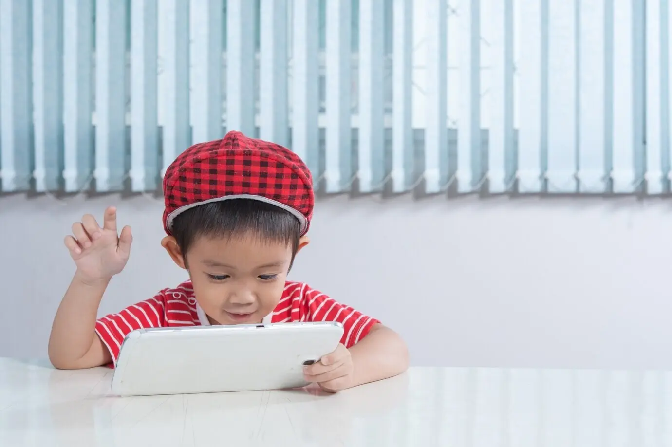 Cute boy playing on a tablet in the children's room